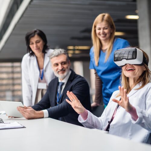 Medical providers sitting at a desk and using a VR headset