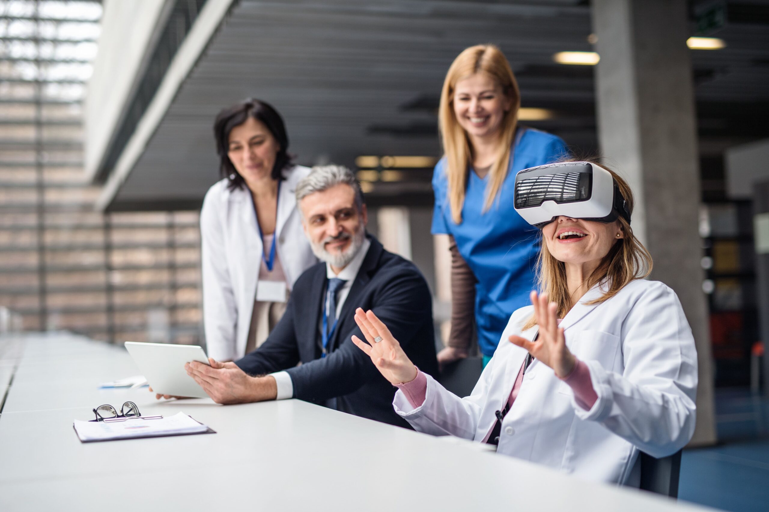 Medical providers sitting at a desk and using a VR headset